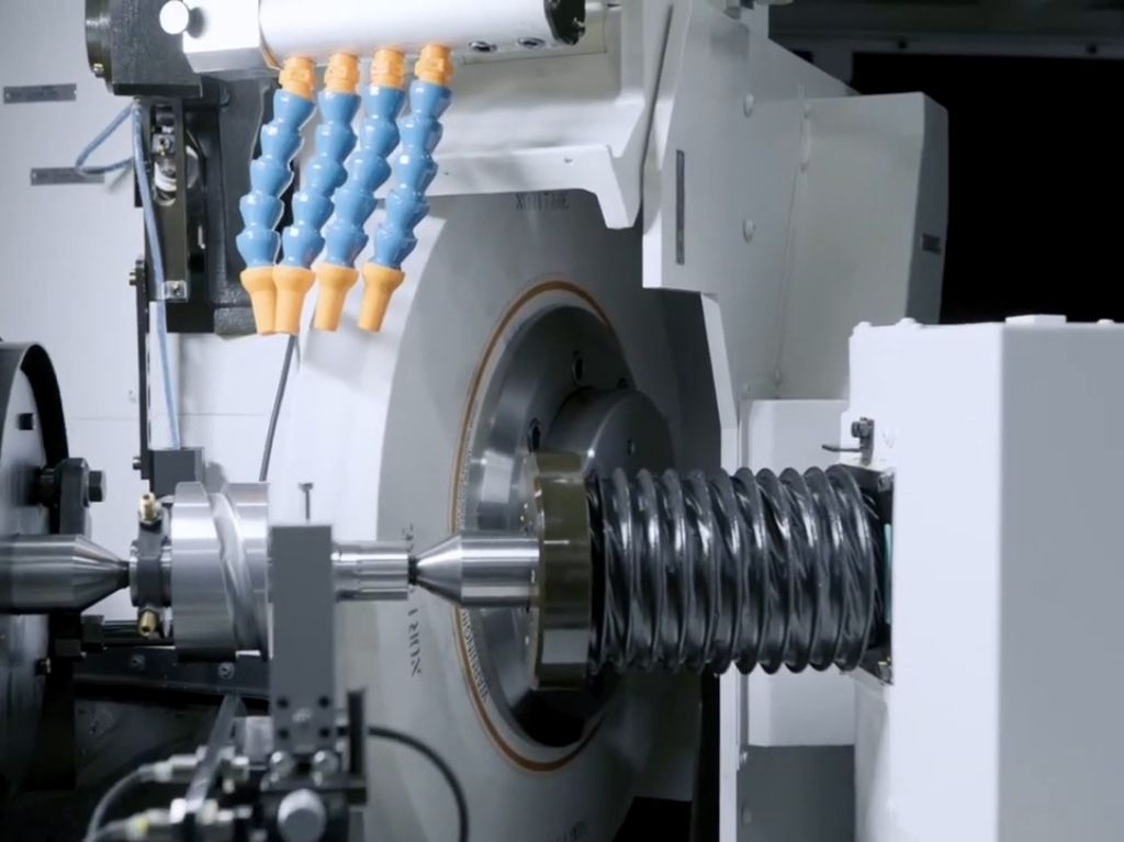 Grinders Close-up of a CNC grinder refining a cylindrical metal part, achieving high surface finish and consistent accuracy for precision applications.