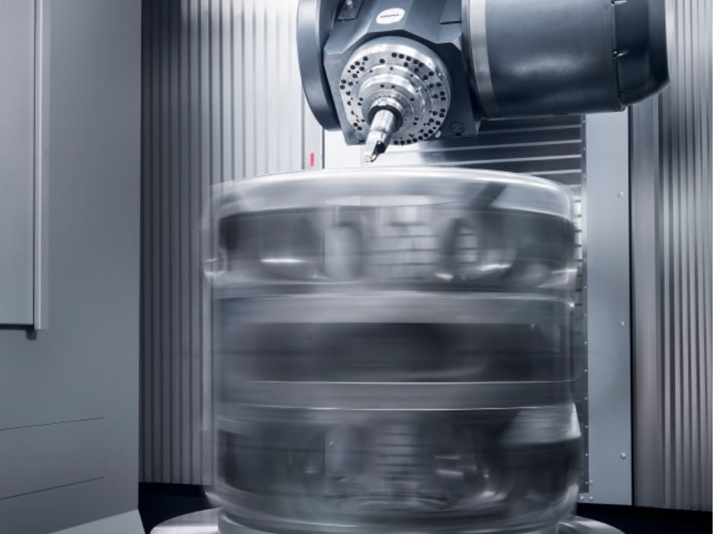 Machining Centers Multi-axis CNC machining center performing milling operations, illustrating versatility and precision for various surfaces and material types.