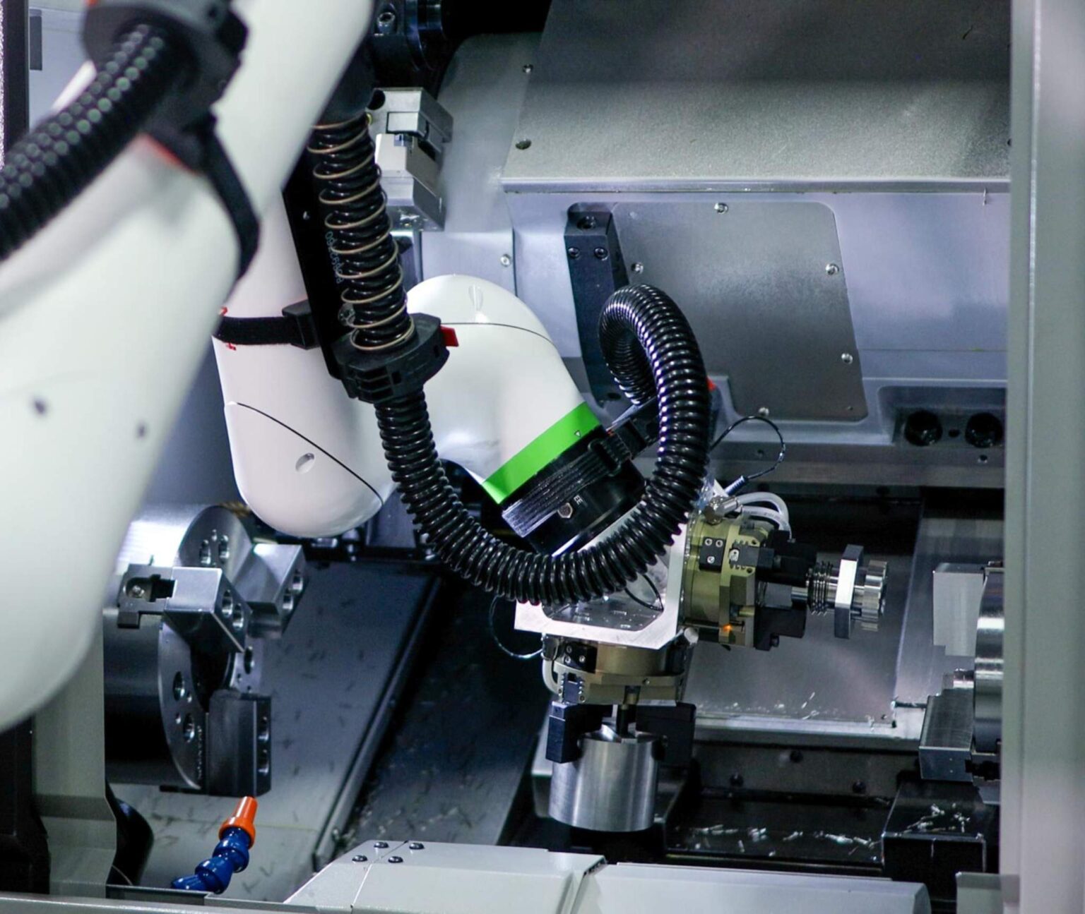 Tsugami America Lathe Cobot oading inside M08SY-II for standard small part manufacturing automation