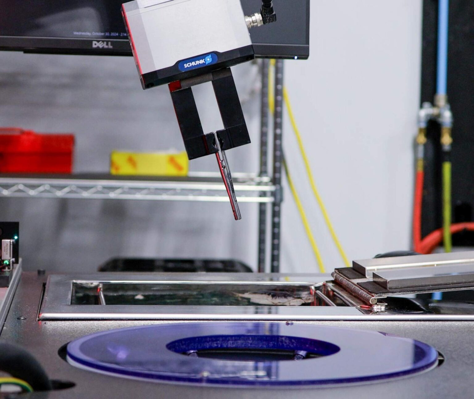 Tsugami America Inspection Cart with cobot picking up part for part washing and drying