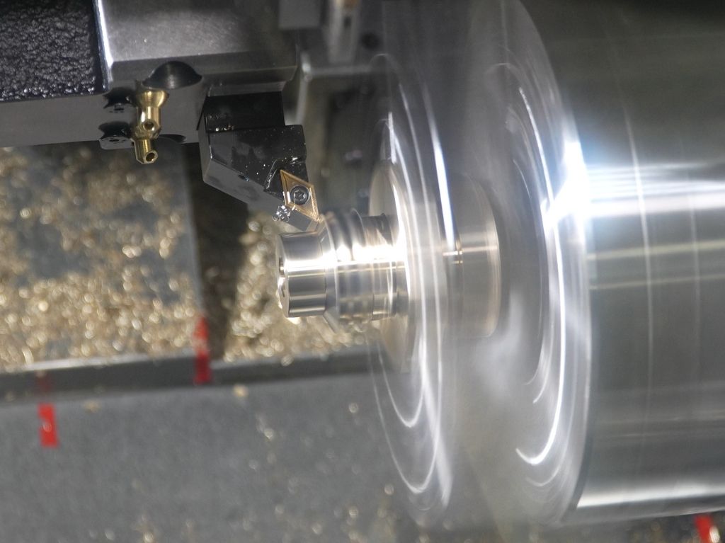 Turning Center Turning center machining a cylindrical metal part, illustrating precision turning capabilities for consistent, repeatable results across various applications.