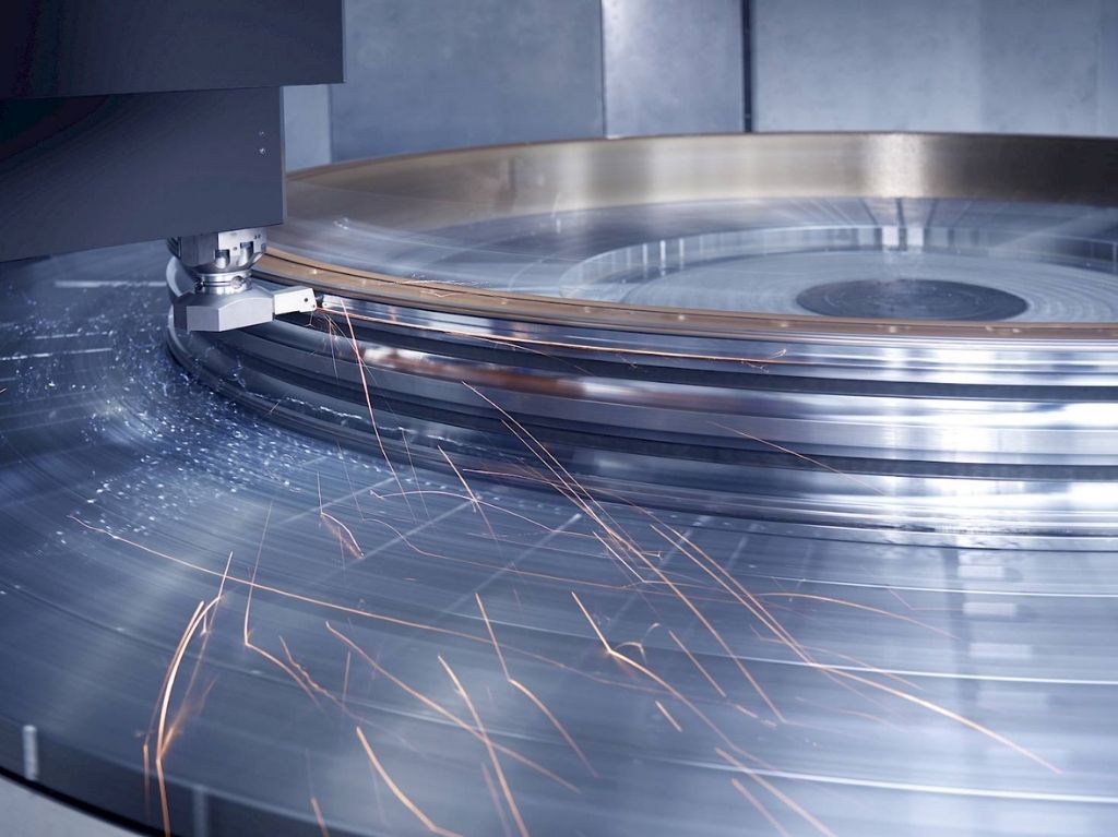 Vertical Lathes (2) CNC vertical lathe machining a large, heavy disc component, utilizing gravity-aided stability for deep cuts and efficient material removal.